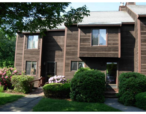 11 Thornhill Road, Unit 11 Stratham, NH 03885 - Photo 1 of 1 a front view of a house with garden