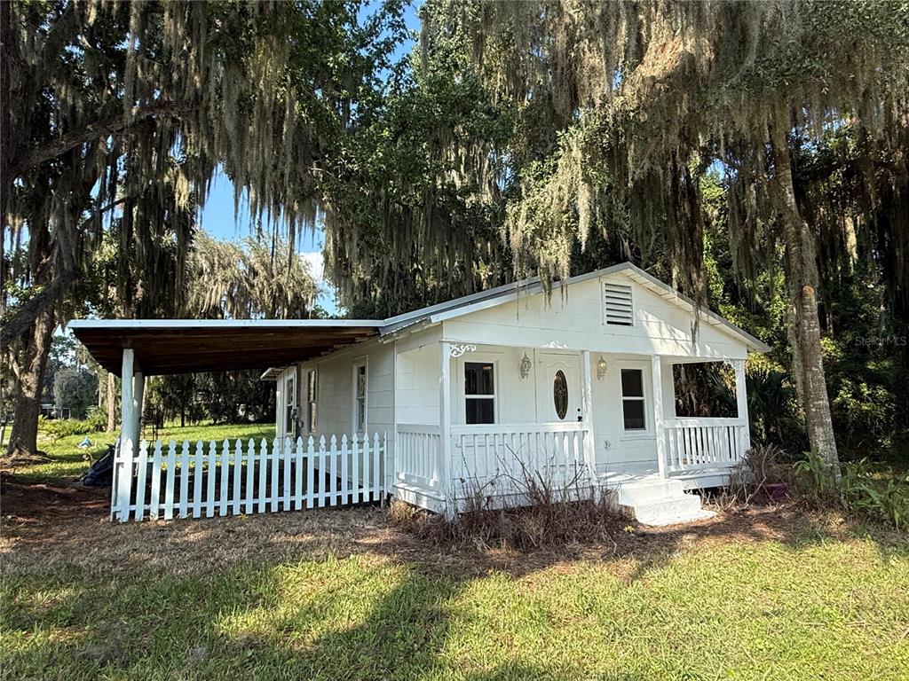 102 Possum Hollow Road Georgetown, FL 32139 - Photo 1 of 24 a front view of a house with a garden