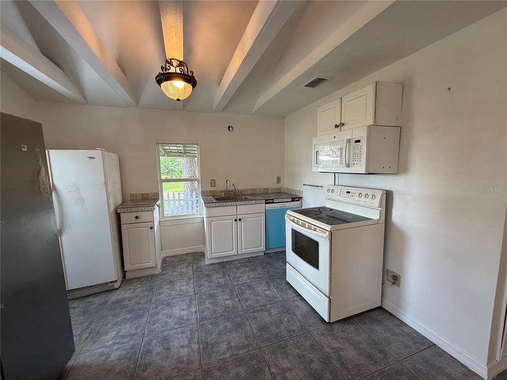 102 Possum Hollow Road Georgetown, FL 32139 - Photo 14 of 24 a kitchen with stainless steel appliances a white stove cabinets and a refrigerator