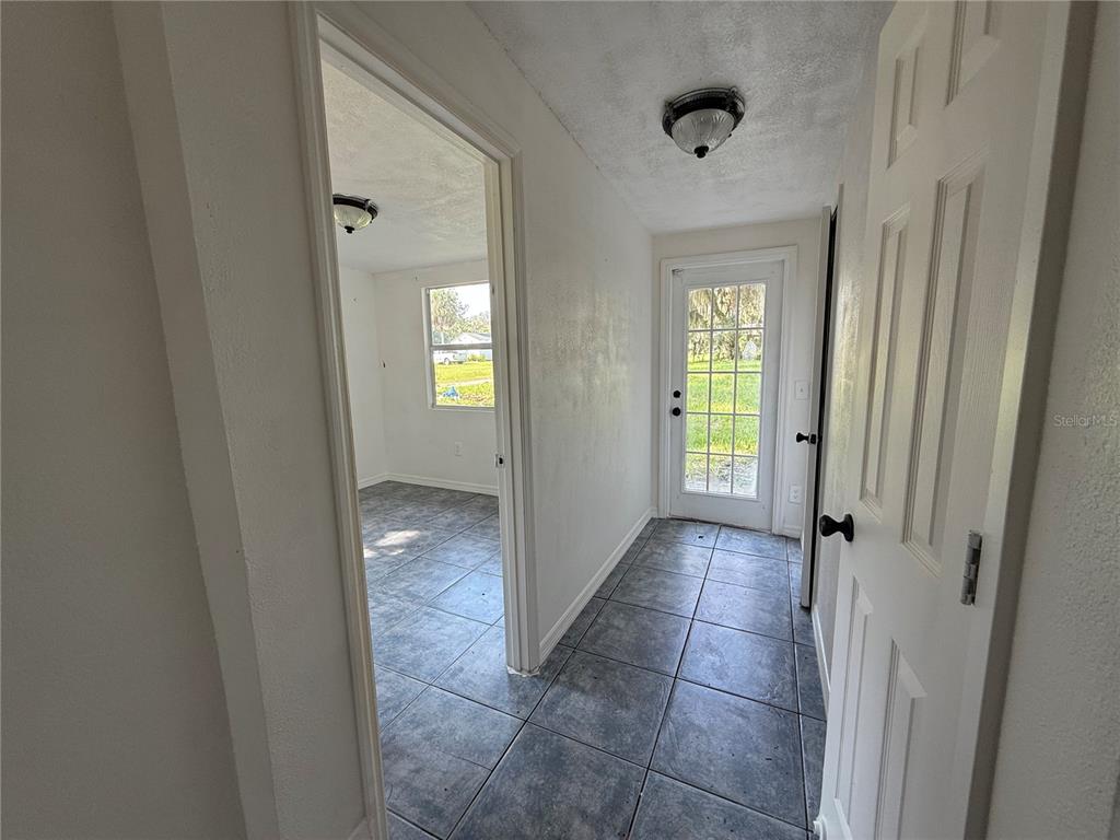 102 Possum Hollow Road Georgetown, FL 32139 - Photo 24 of 24 a view of a hallway with wooden floor and a bathroom