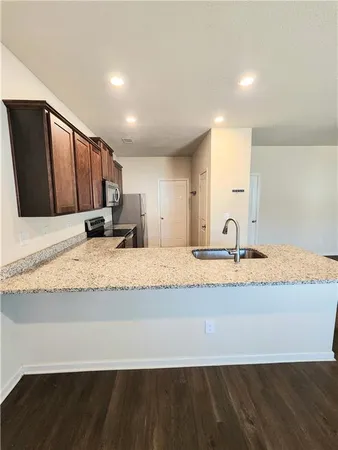 a view of kitchen with granite countertop sink