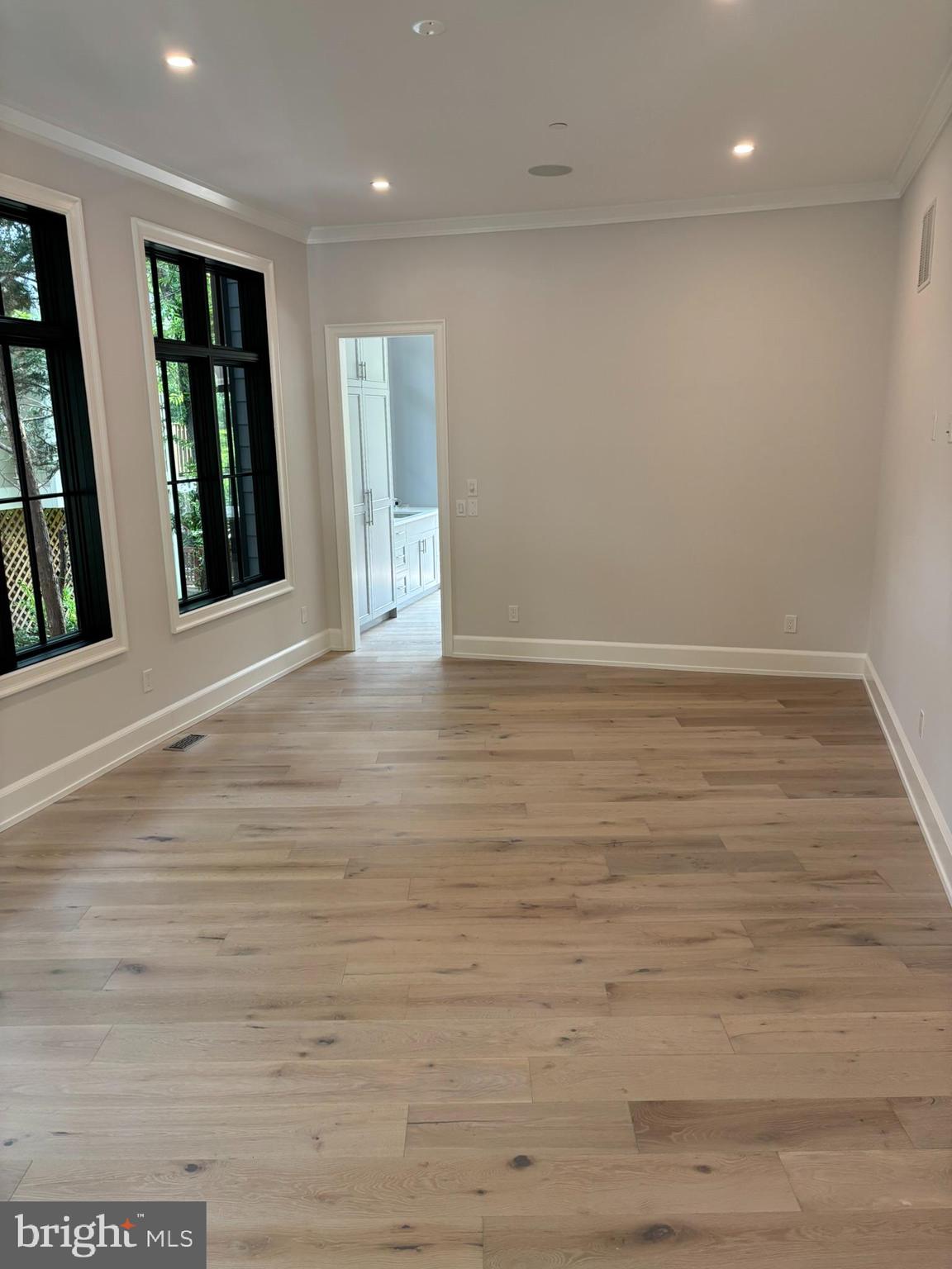 5017 Eskridge Terrace Northwest Washington, DC 20016 - Photo 12 of 45 an empty room with wooden floor and windows