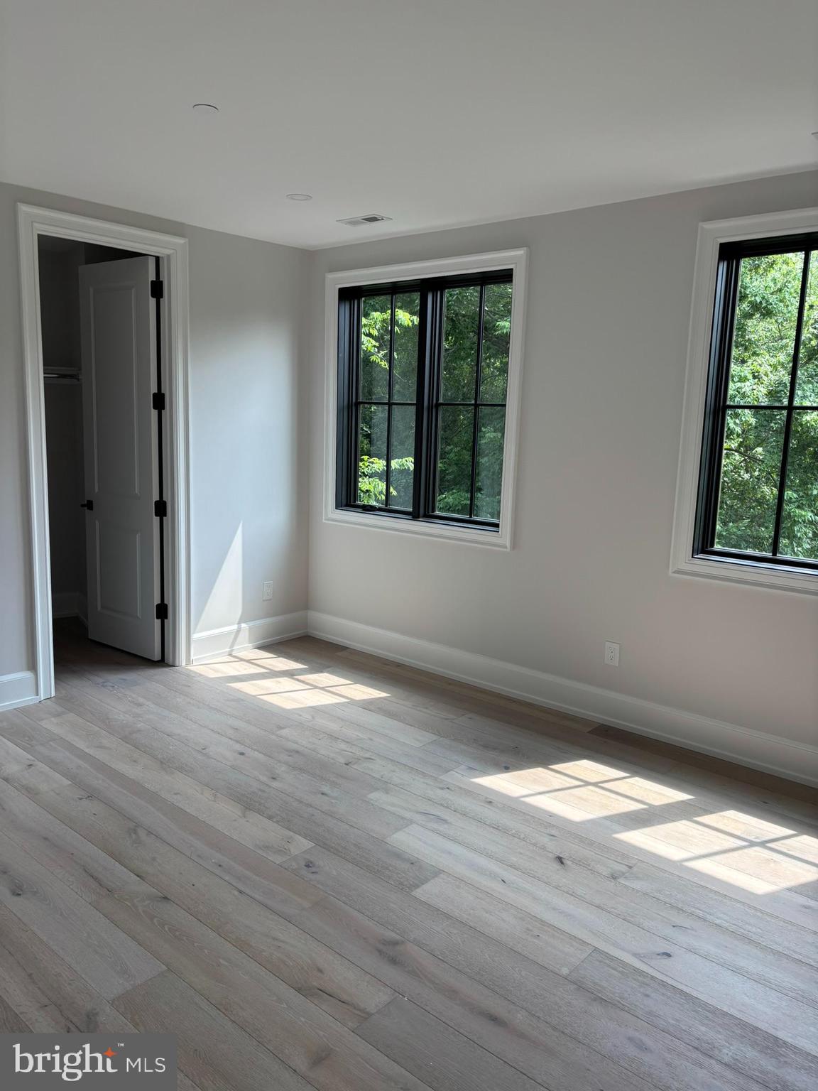 5017 Eskridge Terrace Northwest Washington, DC 20016 - Photo 19 of 45 a view of an empty room with wooden floor and a window
