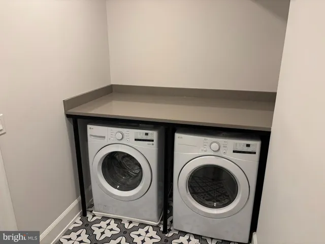 a bathroom with a double vanity sink toilet and mirror