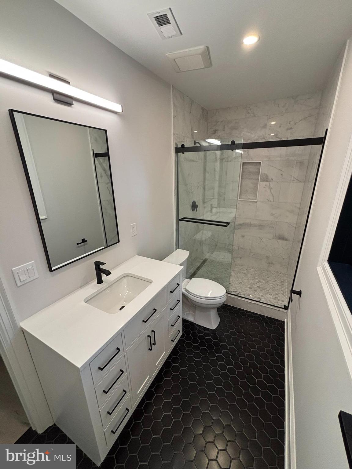 5017 Eskridge Terrace Northwest Washington, DC 20016 - Photo 21 of 45 a bathroom with a double vanity sink toilet and mirror