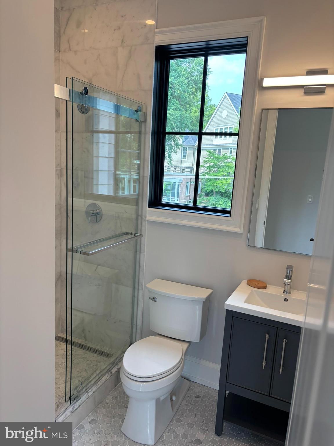 5017 Eskridge Terrace Northwest Washington, DC 20016 - Photo 36 of 45 a bathroom with a sink toilet and shower