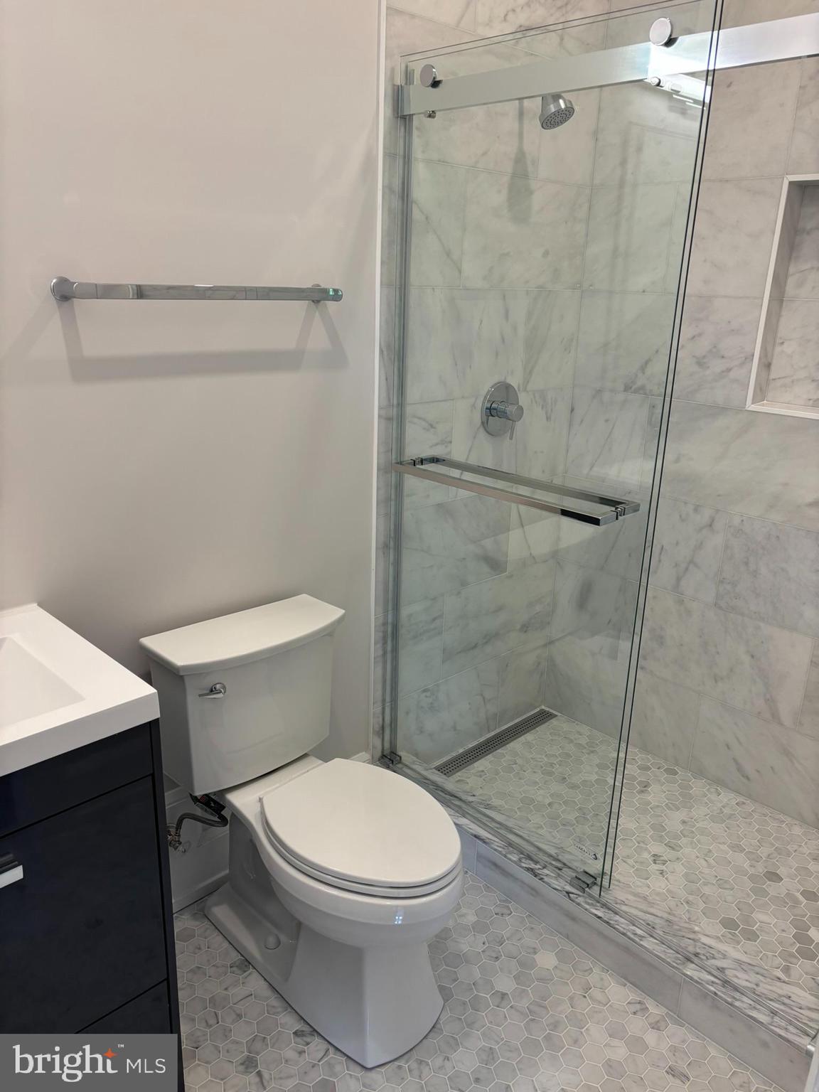 5017 Eskridge Terrace Northwest Washington, DC 20016 - Photo 39 of 45 a white toilet sitting next to a bathroom sink