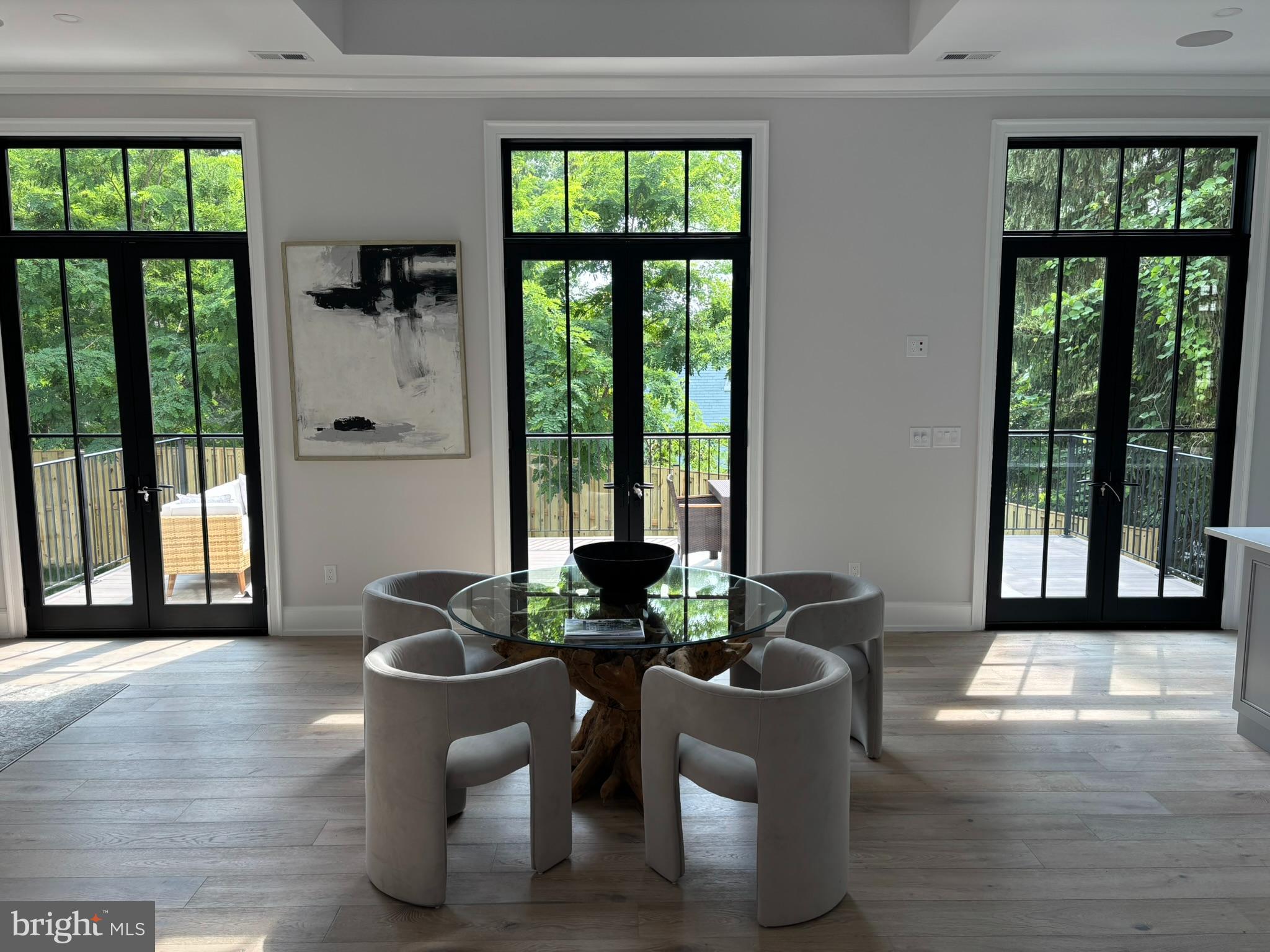 5017 Eskridge Terrace Northwest Washington, DC 20016 - Photo 5 of 45 a dining room with furniture wooden floor and a potted plant