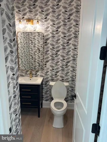 a view of a kitchen with wooden floor and electronic appliances