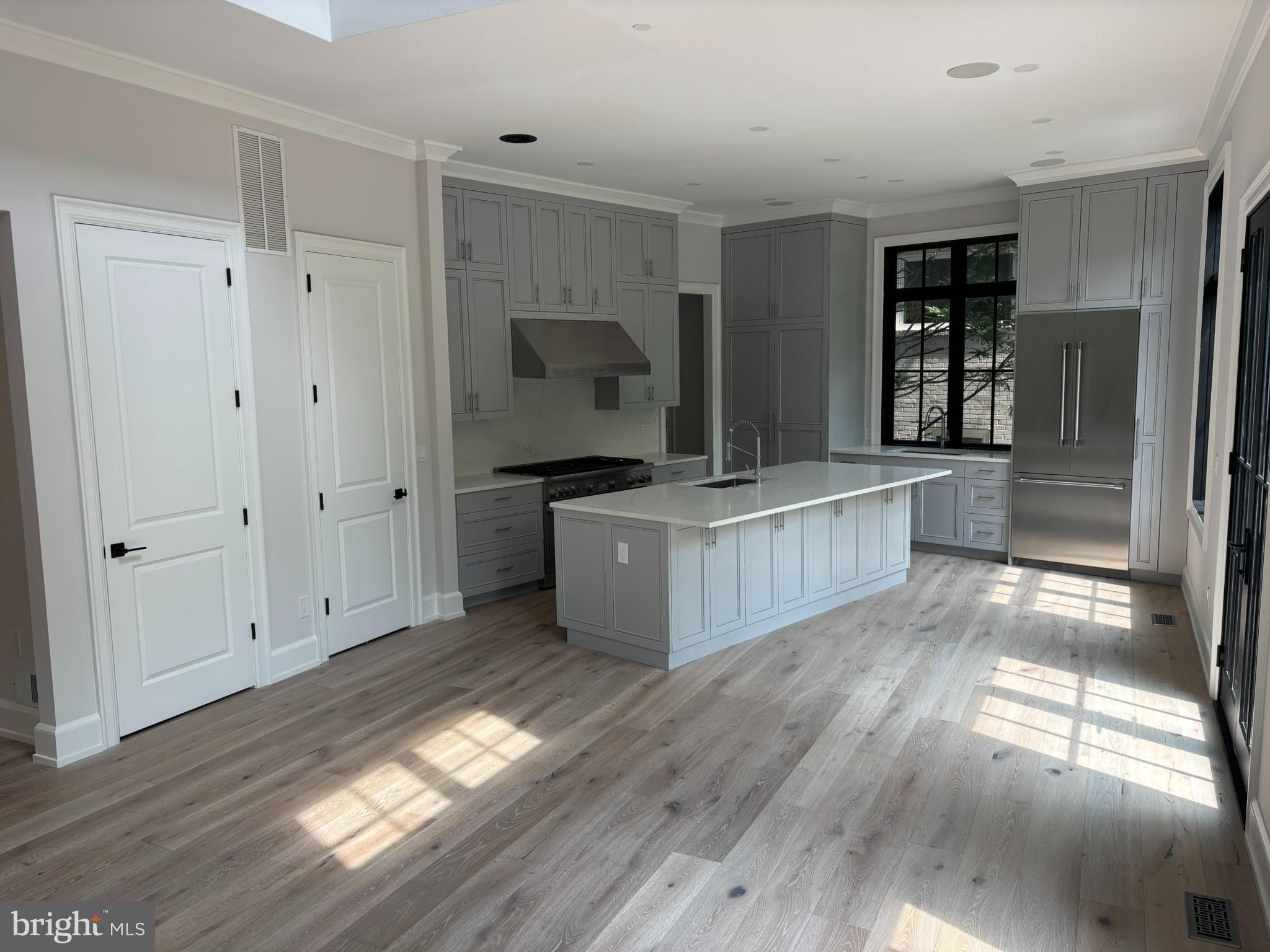 5017 Eskridge Terrace Northwest Washington, DC 20016 - Photo 8 of 45 a view of a kitchen with wooden floor and electronic appliances