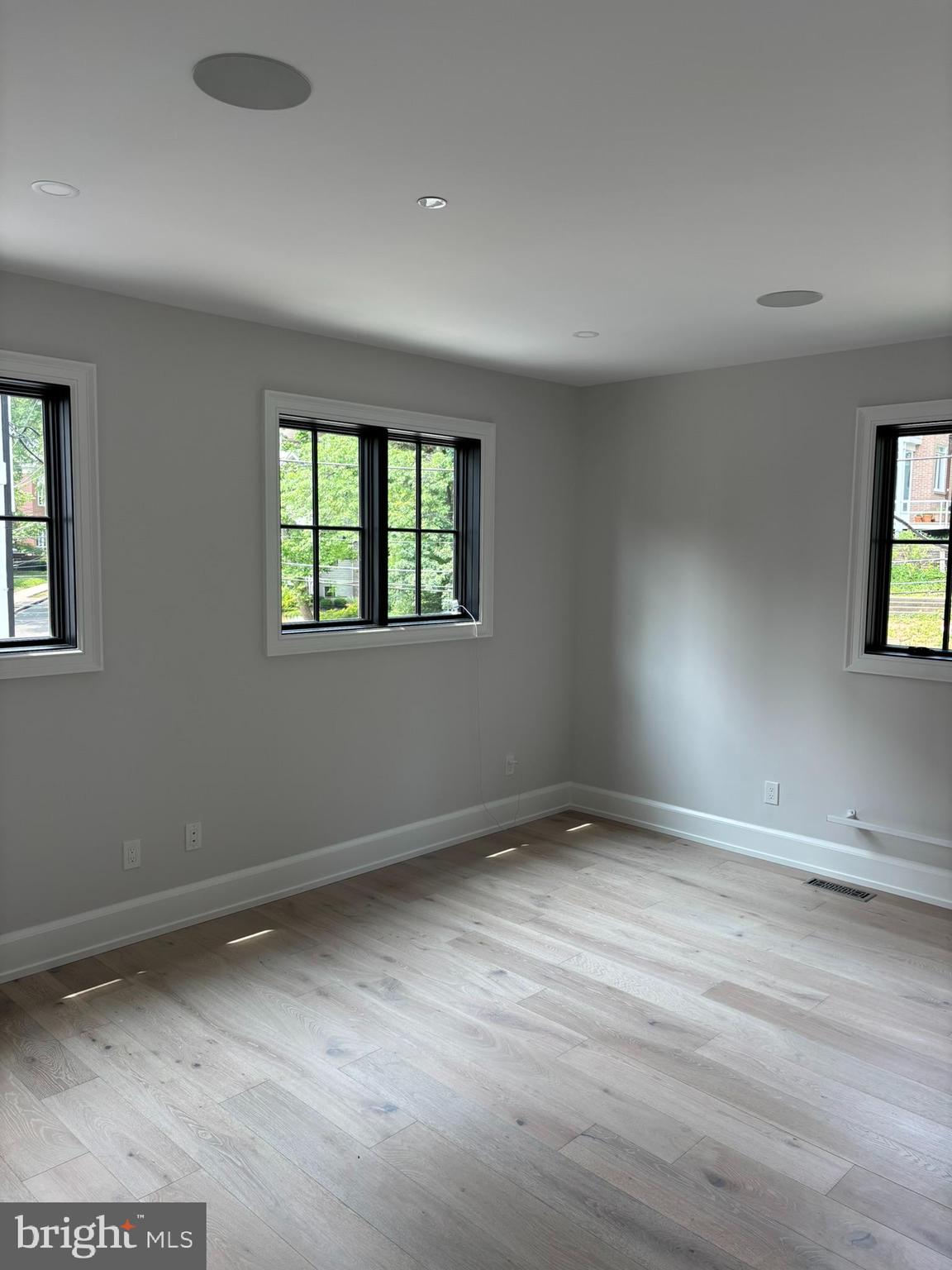 5017 Eskridge Terrace Northwest Washington, DC 20016 - Photo 9 of 45 an empty room with wooden floor and windows