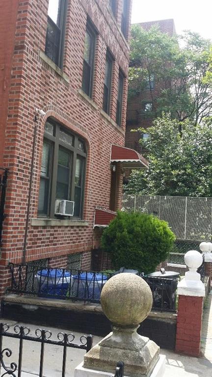 315 East 94th Street Brooklyn, NY 11212 - Photo 2 of 6 a front view of a house with a garden and patio