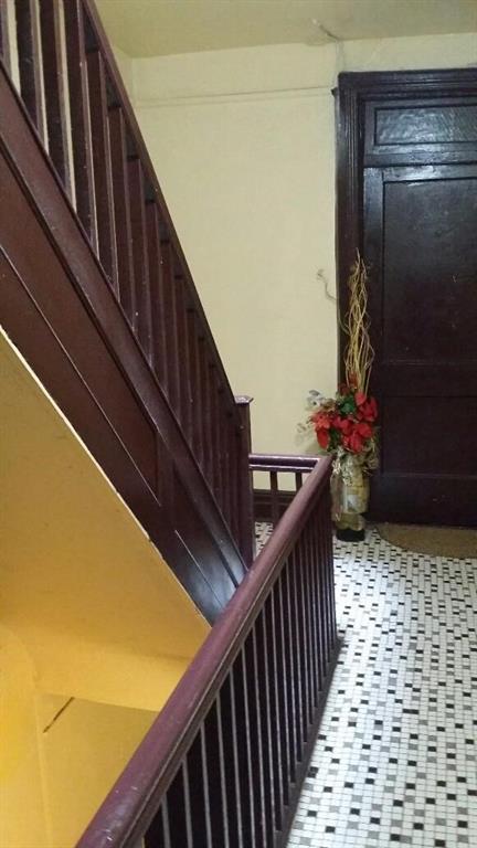 315 East 94th Street Brooklyn, NY 11212 - Photo 5 of 6 a view of stairs and wooden floor