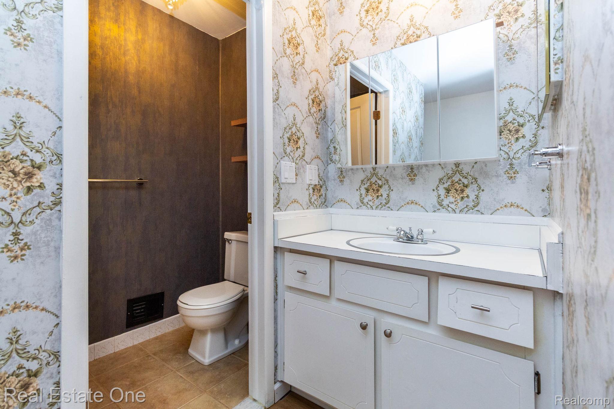 111 Manor Way Rochester, MI 48309 - Photo 18 of 36 Vanity with white cabinetry, integrated sink, and white countertop