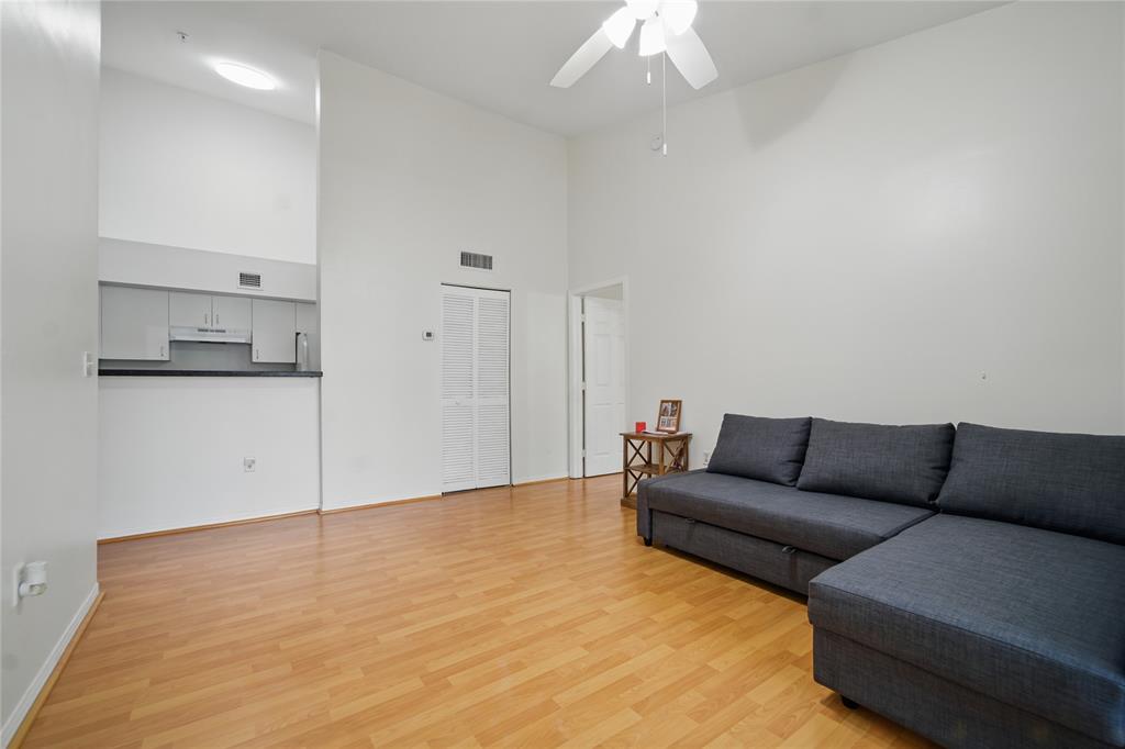 11133 Southwest 8th Street, Unit 306 Pembroke Pines, FL 33025 - Photo 4 of 14 a living room with furniture and a chandelier
