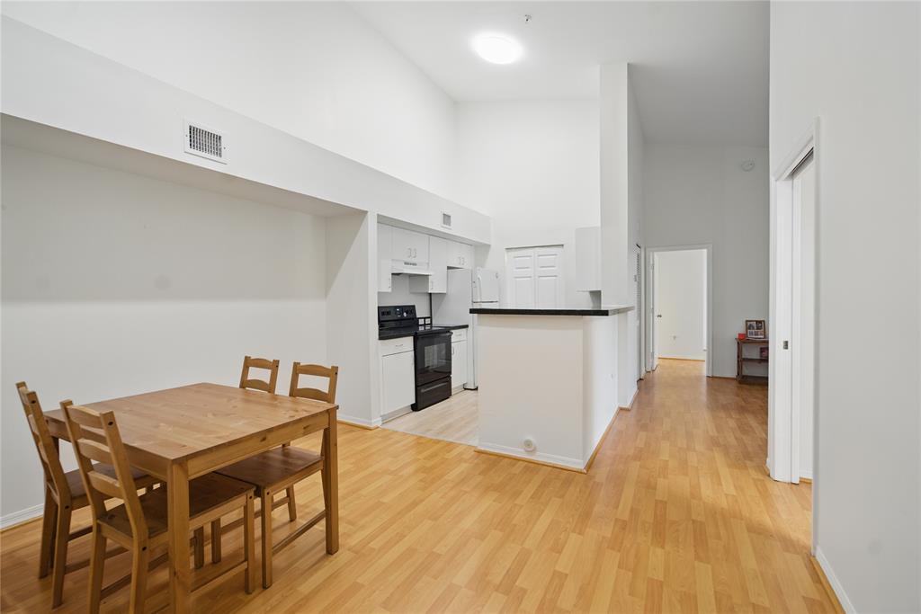 11133 Southwest 8th Street, Unit 306 Pembroke Pines, FL 33025 - Photo 5 of 14 a kitchen with a table and chairs in it