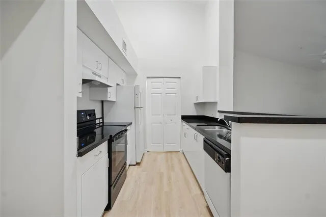 a kitchen with stainless steel appliances granite countertop a stove and a refrigerator