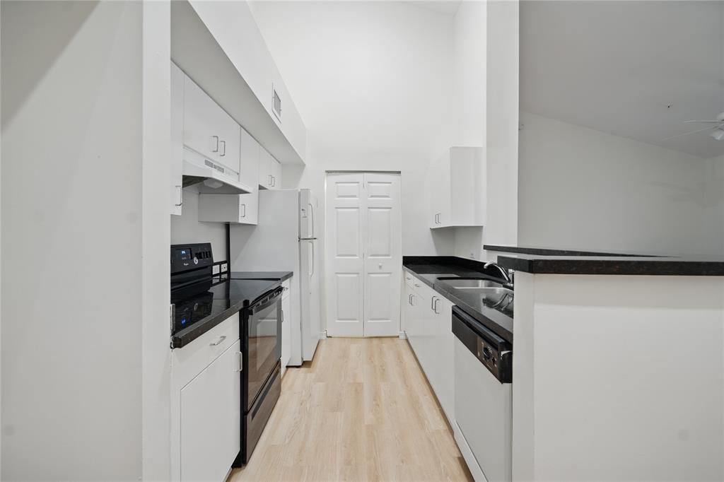 11133 Southwest 8th Street, Unit 306 Pembroke Pines, FL 33025 - Photo 7 of 14 a kitchen with stainless steel appliances granite countertop a stove and a refrigerator