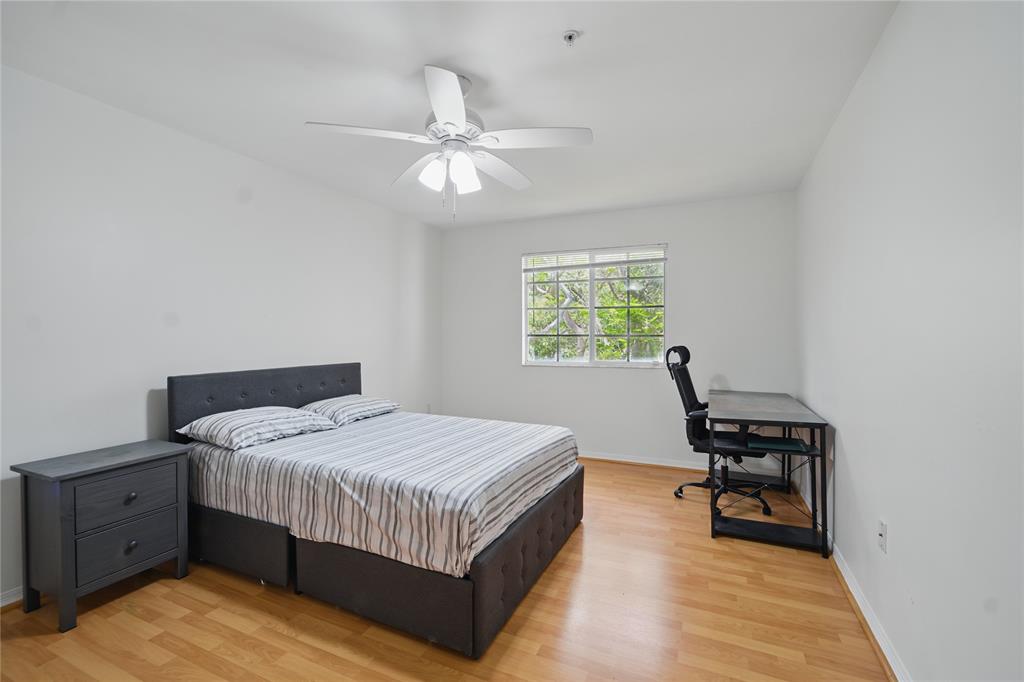 11133 Southwest 8th Street, Unit 306 Pembroke Pines, FL 33025 - Photo 8 of 14 a bedroom with a bed and a window