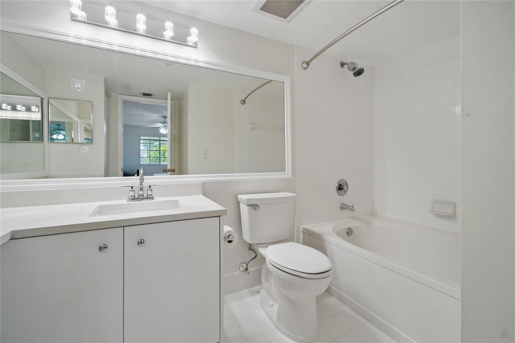 11133 Southwest 8th Street, Unit 306 Pembroke Pines, FL 33025 - Photo 9 of 14 a bathroom with a toilet a sink a mirror a bathtub and vanity
