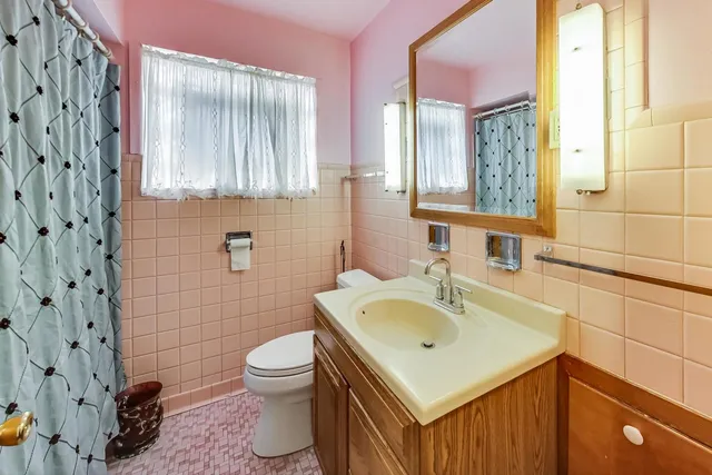 a bathroom with a sink mirror and toilet