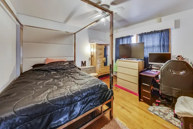 a bed room with a bed and a television