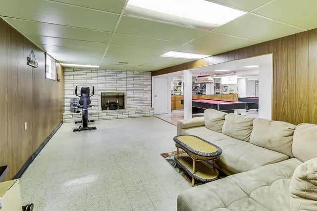 a living room with furniture gym equipment and a fireplace