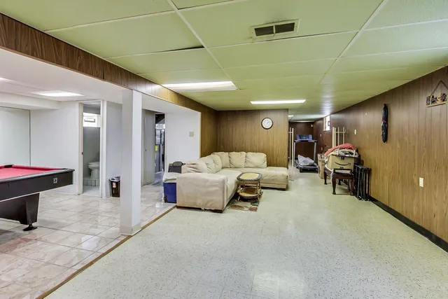 a room with furniture and pool table