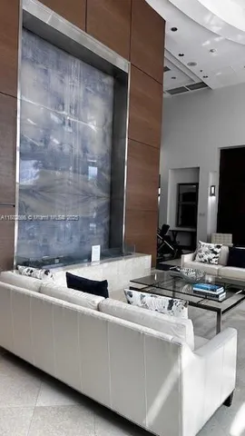 a view of living room with furniture and a flat screen tv