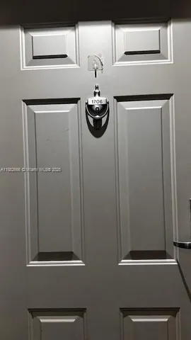 a kitchen with a refrigerator and a stove top oven