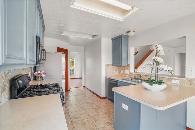 a kitchen with a sink stove and cabinets