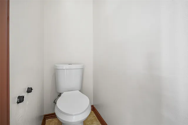 a white toilet sitting in a bathroom