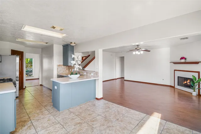 a view of a kitchen with a sink and a fireplace