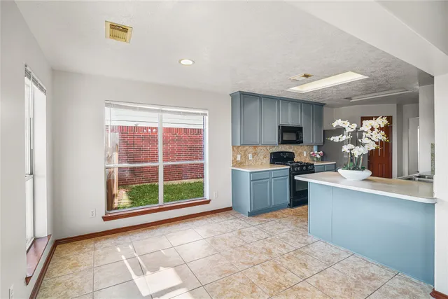 a kitchen with a stove a sink and a refrigerator