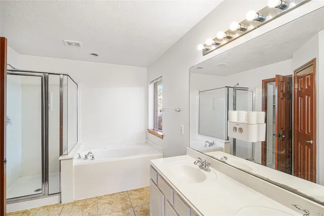 a bathroom with a bathtub a sink and a mirror