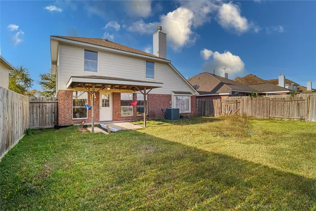 a view of a house with a tub and a yard