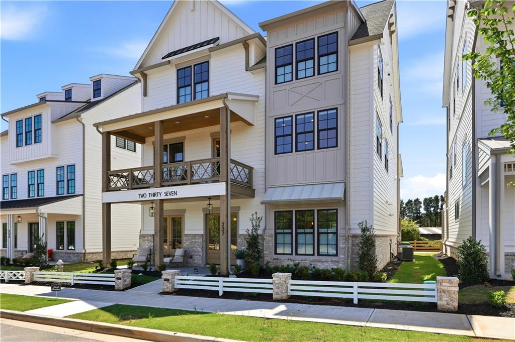 237 Lask Lane Milton, GA 30004 - Photo 4 of 63 a front view of residential houses with yard and furniture
