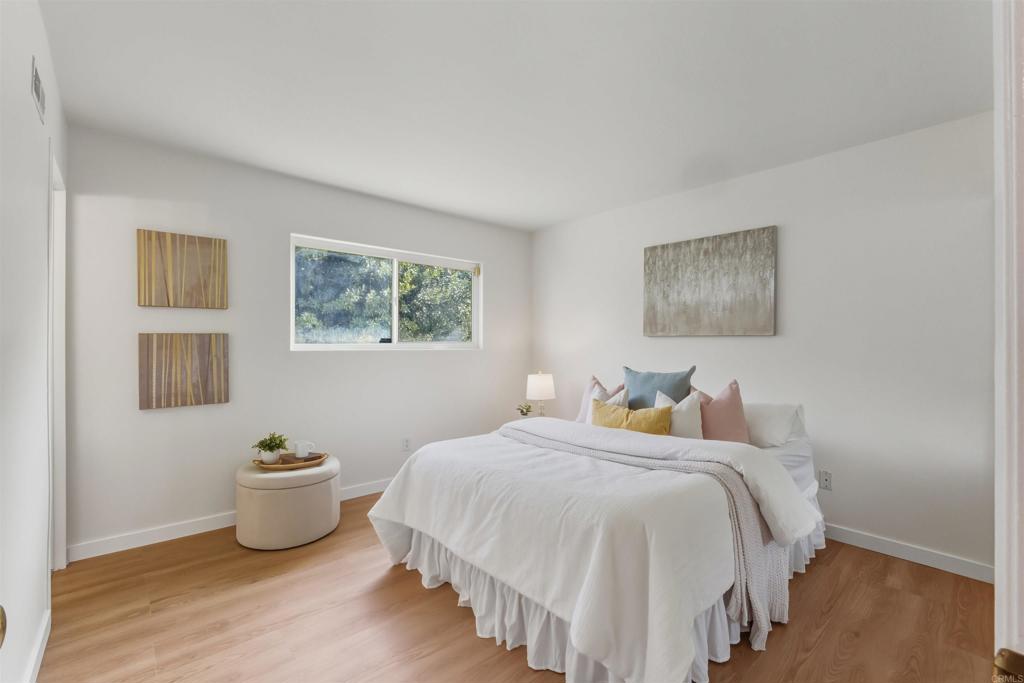 9909 Halberns Boulevard Santee, CA 92071 - Photo 13 of 35 a bedroom with a bed and a painting on the wall
