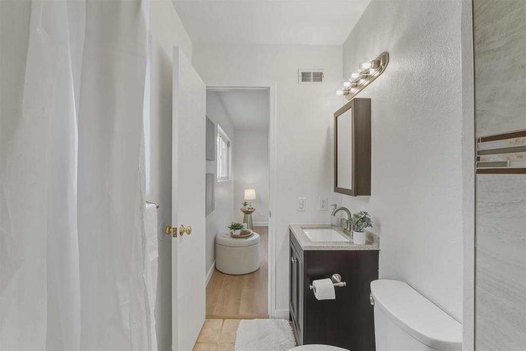 9909 Halberns Boulevard Santee, CA 92071 - Photo 16 of 35 a bathroom with a sink and mirror with toilet