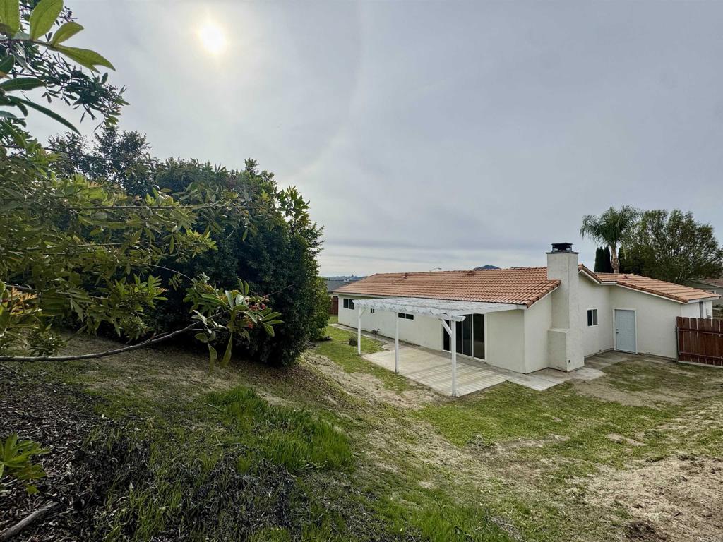 9909 Halberns Boulevard Santee, CA 92071 - Photo 27 of 35 a front view of a house with a garden