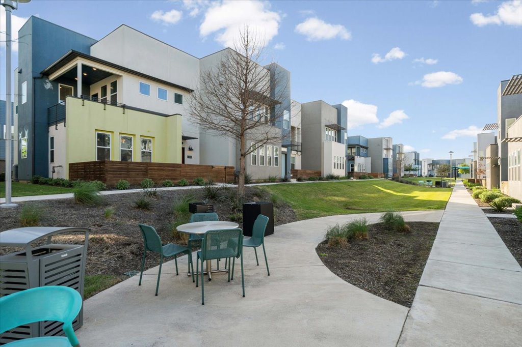 9015 Cattle Baron Path, Unit 705 Austin, TX 78747 - Photo 3 of 35 a view of a building with a garden