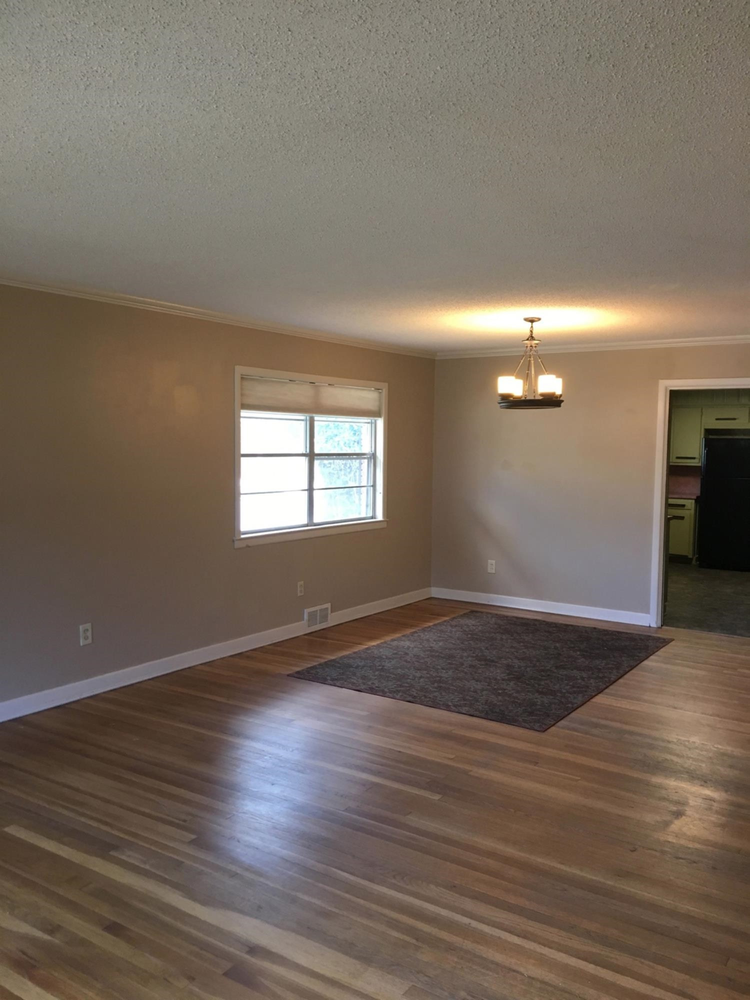 2801 20th Street Lubbock, TX 79410 - Photo 6 of 10 a view of an empty room with wooden floor and a window
