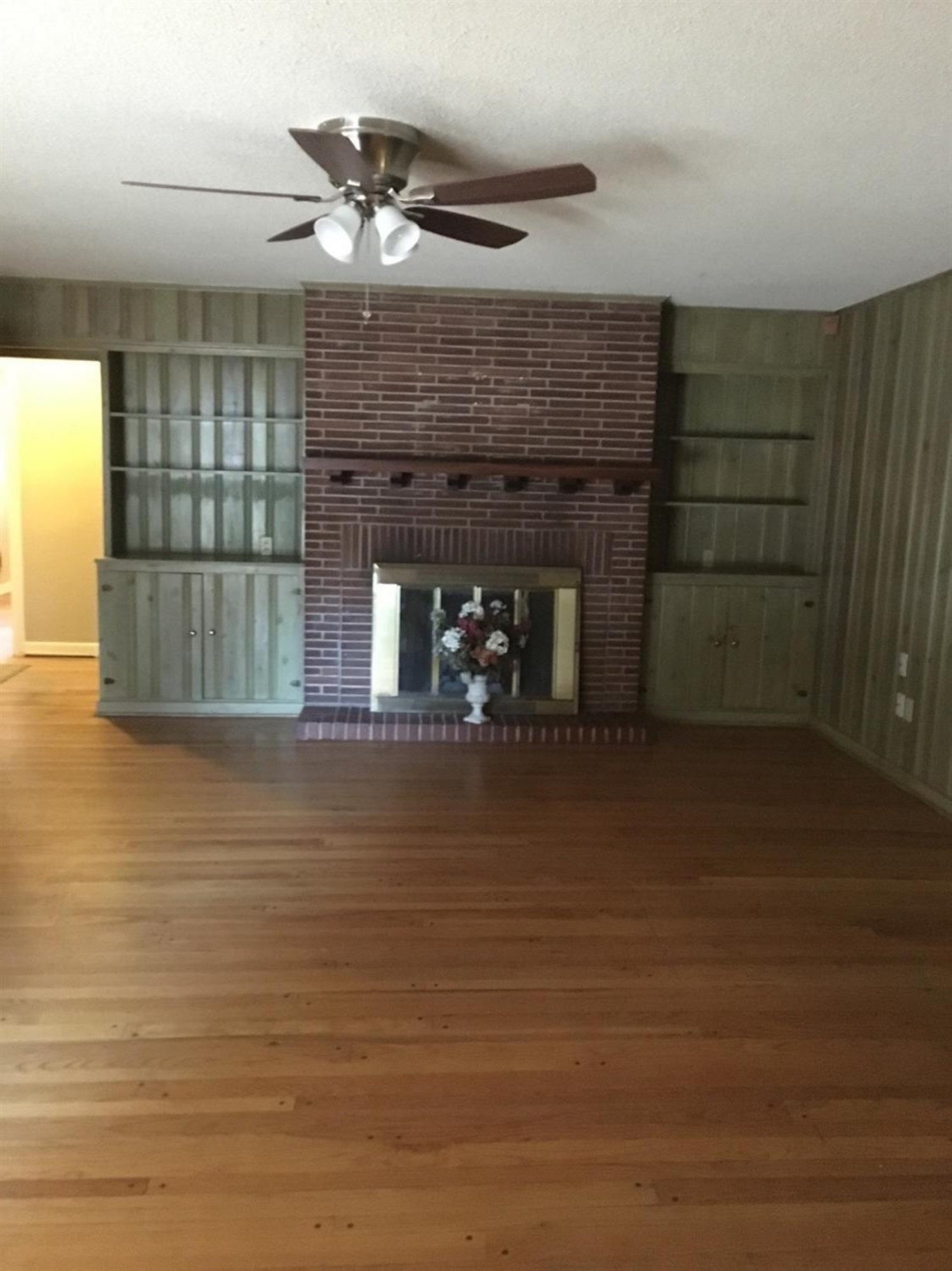 2801 20th Street Lubbock, TX 79410 - Photo 7 of 10 a living room with fireplace furniture and a wooden floor