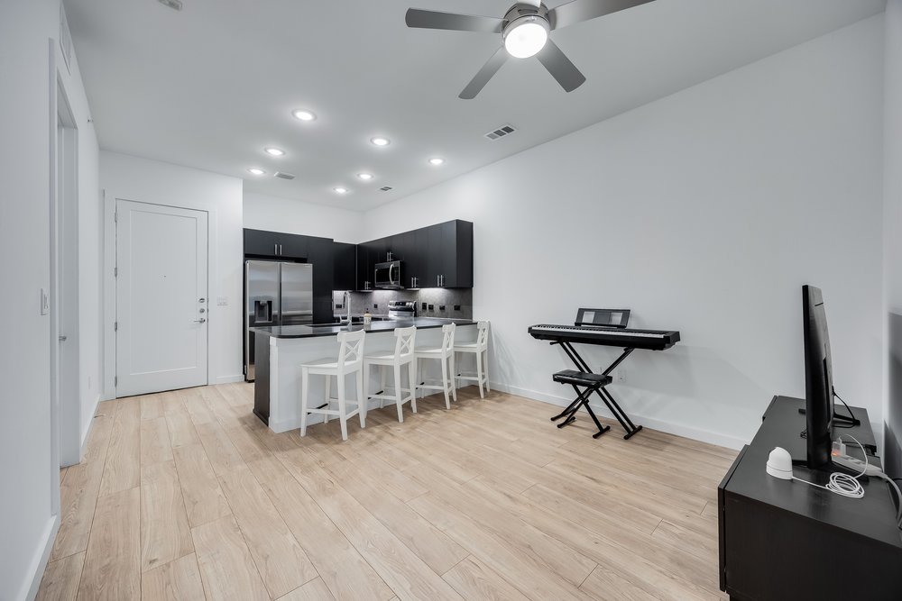 4801 Springdale Road, Unit 2107 Austin, TX 78723 - Photo 8 of 26 a view of a dining room with furniture and a flat screen tv