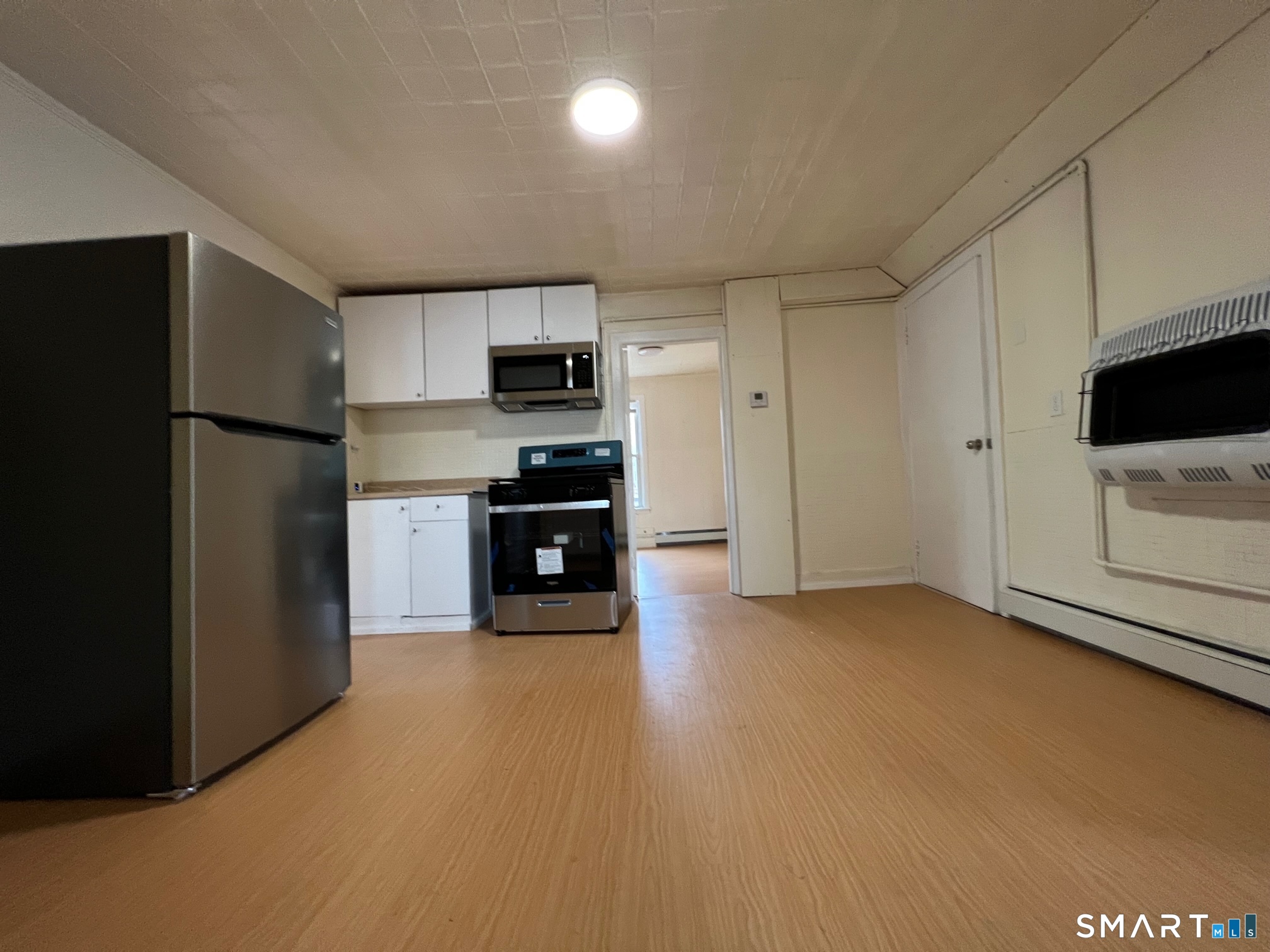 62 North Leonard Street Waterbury, CT 06708 - Photo 4 of 13 a kitchen with stainless steel appliances a refrigerator and a stove