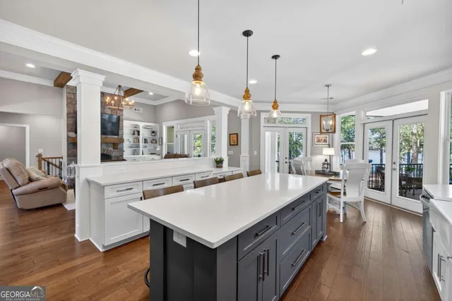 a view of a dining room with furniture large windows and wooden floor