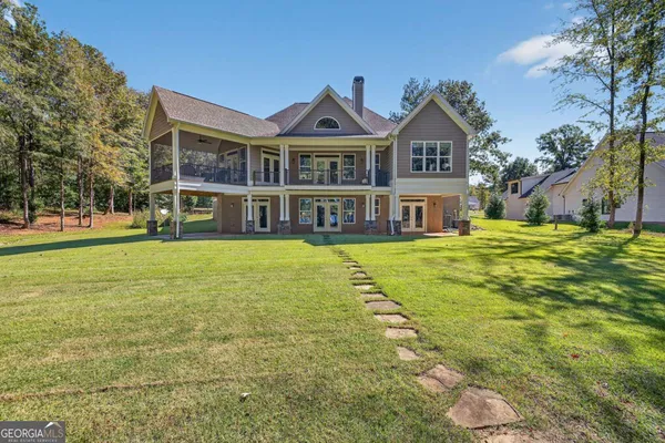 a front view of a house with a garden