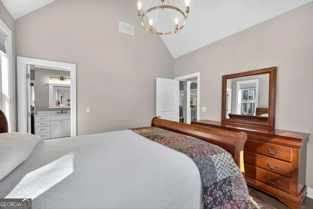 a bedroom with a bed a desk and chair