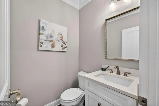 a bed sitting in a spacious bedroom next to a window