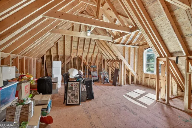 an aerial view of a house with a yard and lake view